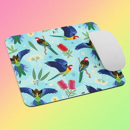 Mouse pad with an eastern rosella parrot design and a white mouse on a gradient background