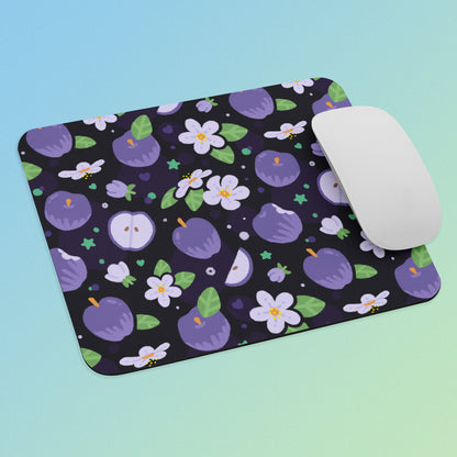 Mouse pad with purple fruit and flower pattern and a white mouse on a blue and green gradient background