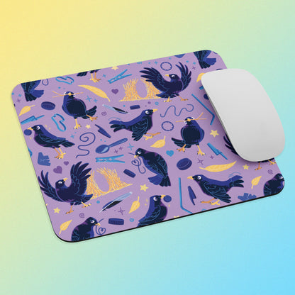Purple mouse pad with a satin bowerbird pattern and a white mouse on a gradient background