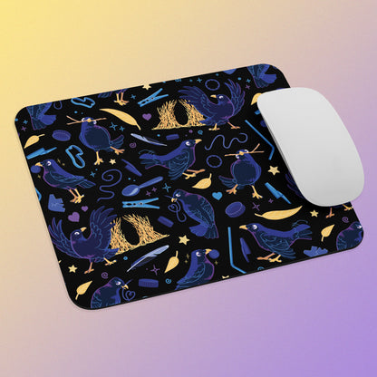 Dark blue-black mouse pad with a colourful satin bowerbird pattern and a white mouse on a gradient background