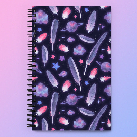 Spiral notebook with a pink, purple and blue space-themed galaxy galah cockatoo feather pattern on a pink and purple gradient background.