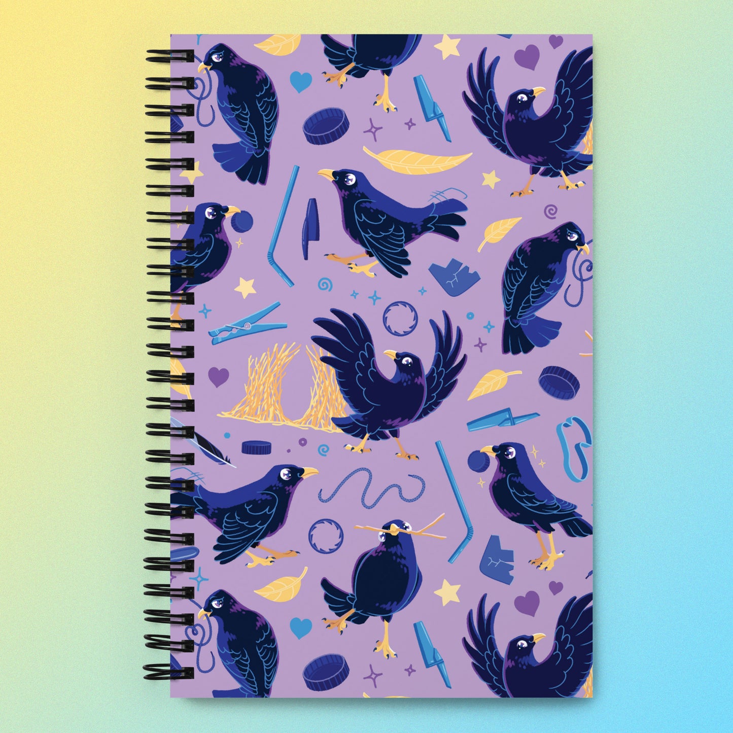Spiral notebook with a colourful purple, blue and yellow satin bowerbird pattern on a yellow and blue gradient background.