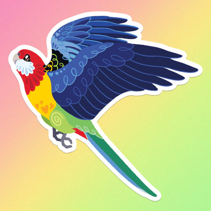 Colourful sticker of an Eastern Rosella in flight on a pink, orange, yellow and green gradient background.
