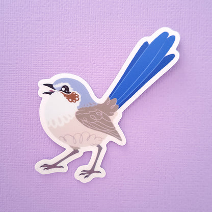 Real photo of a colourful sticker of a female Purple-Crowned Fairywren chirping on a purple canvas textured gradient background.