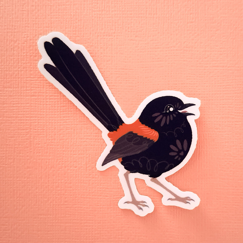 Real photo of a colourful sticker of a male Red-backed Fairywren chirping on a peach canvas texturedbackground.