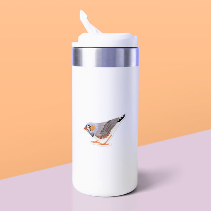 Colourful die-cut sticker of a male Australian zebra finch stuck to a white metal drink bottle on a soft lilac table on an orange background.