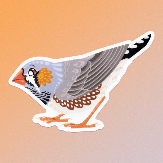 Colourful die-cut sticker of a male Australian zebra finch on a soft orange and beige gradient background.