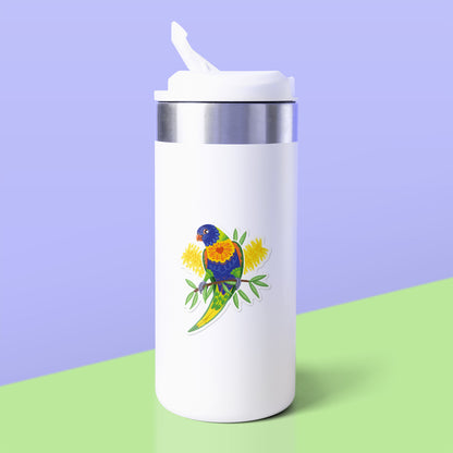 Colourful sticker of a rainbow lorikeet with yellow bottlebrush flowers stuck to a white metal drink bottle on a green table on an lilac background.
