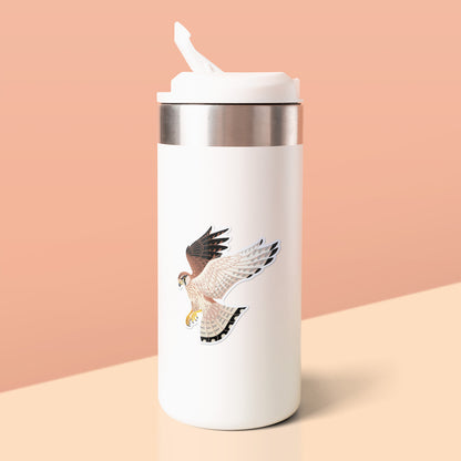 Colourful sticker of a hovering female nankeen kestrel stuck to a white metal drink bottle on a soft yellow table on an orange background.