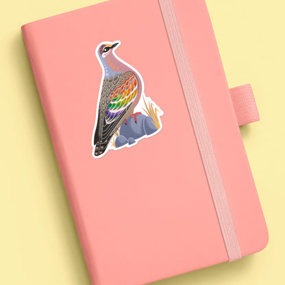 Colourful die-cut sticker of a male common bronzewing pigeon stuck to a pale peach journal on an soft yellow background.