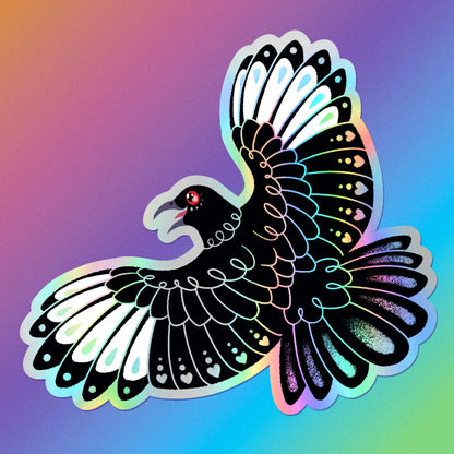 Colourful holographic metallic die-cut sticker of a white-winged chough with spread wings on a rainbow gradient background. 