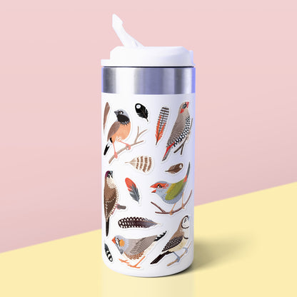 Assorted Australian finches & feathers (Zebra, Double-Barred, Plum-Headed, Red-Browed Firetail, Red-Eared Firetail, Black-Throated) stickers stuck to a white metal drink bottle on a yellow table on a peach background.