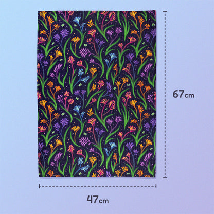 47x67cm tea towel with a rainbow kangaroo paw pattern sitting on a pastel blue and purple background.