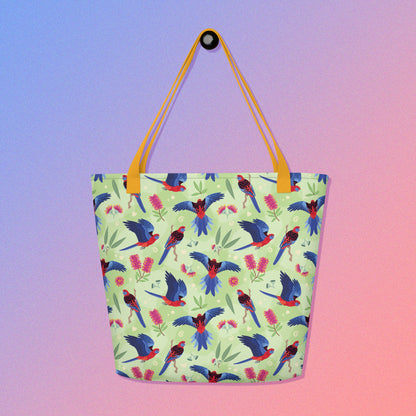 Tote bag with yellow handles and a crimson rosella parrot pattern on a gradient purple and pink background