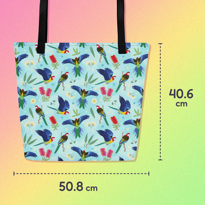 50.8 x 40.6cm tote bag with black handles and an eastern rosella parrot pattern on a gradient pink, yellow and green background.