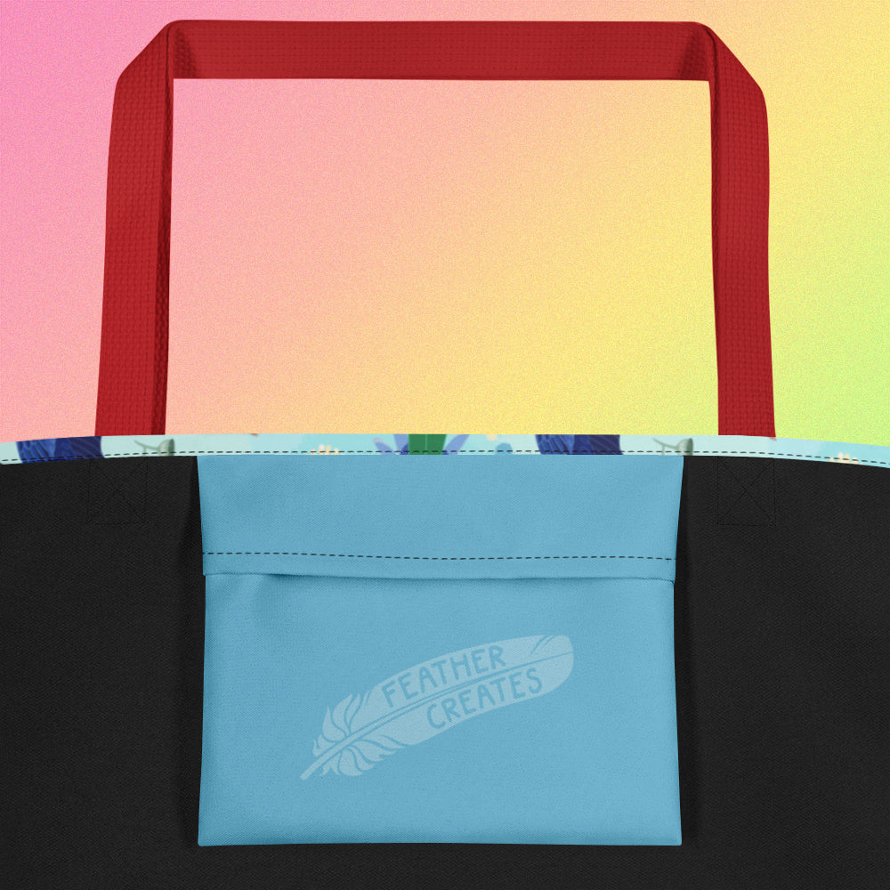 Close up of a blue fold-over pocket on the inside of a tote bag with a red strap on a gradient pink, yellow and green background.