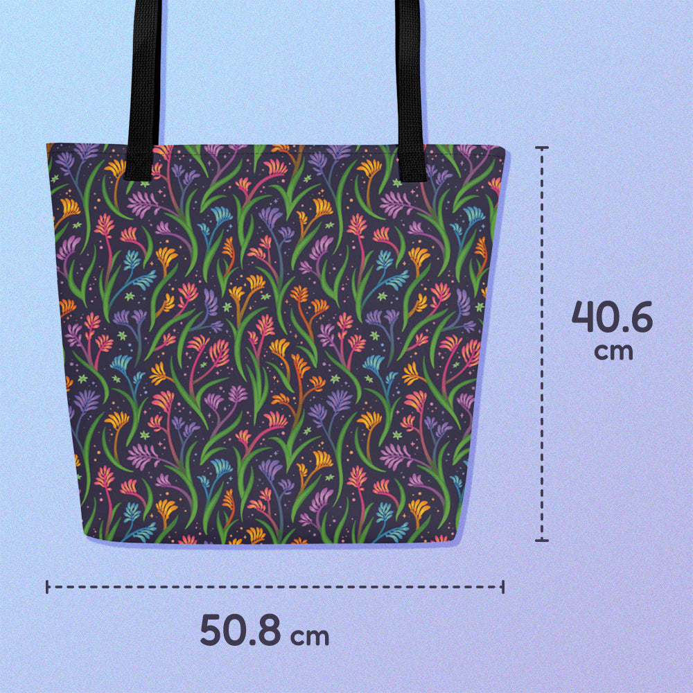 50.8 x 40.6cm tote bag with a black strap and a floral rainbow kangaroo paw pattern on a gradient blue and purple background.