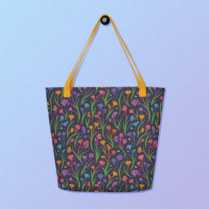 Tote bag with a yellow strap and a floral rainbow kangaroo paw pattern on a gradient blue and purple background.