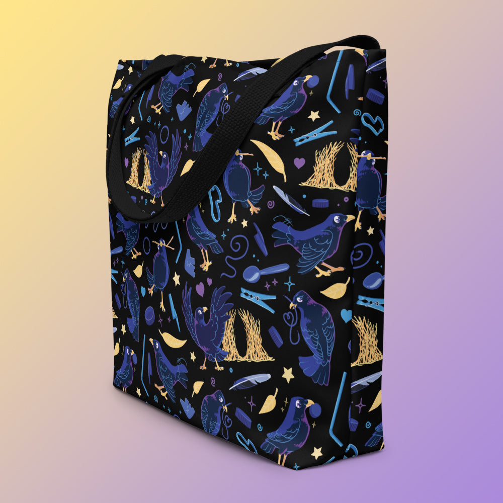 Tote bag on an angle with black handles and a black/blue/yellow satin bowerbird pattern pattern on a yellow and purple gradient background.