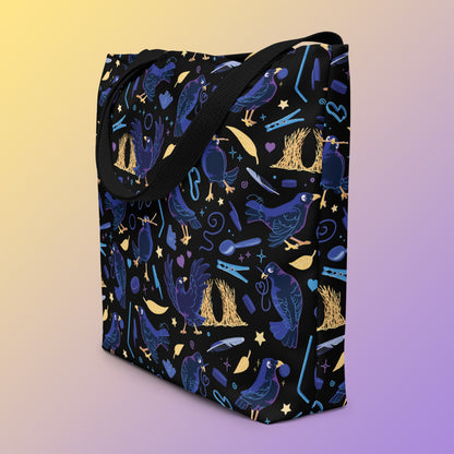 Tote bag on an angle with black handles and a black/blue/yellow satin bowerbird pattern pattern on a yellow and purple gradient background.