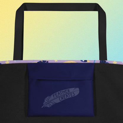 Close up of a dark blue fold-over pocket on the inside of a tote bag with a black strap on a gradient blue and yellow background.