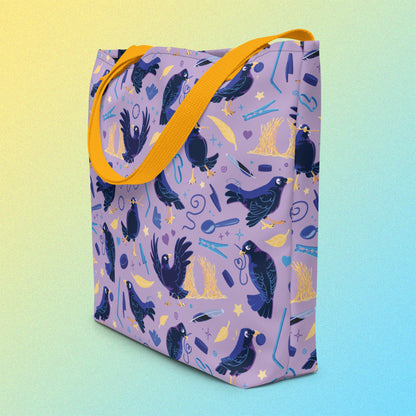 Tote bag on an angle with yellow handles and a purple/blue/yellow satin bowerbird pattern on a yellow and blue gradient background.