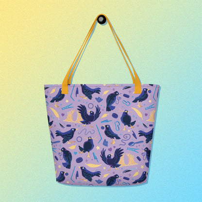 Tote bag with yellow handles and a purple/blue/yellow satin bowerbird pattern on a yellow and blue gradient background.