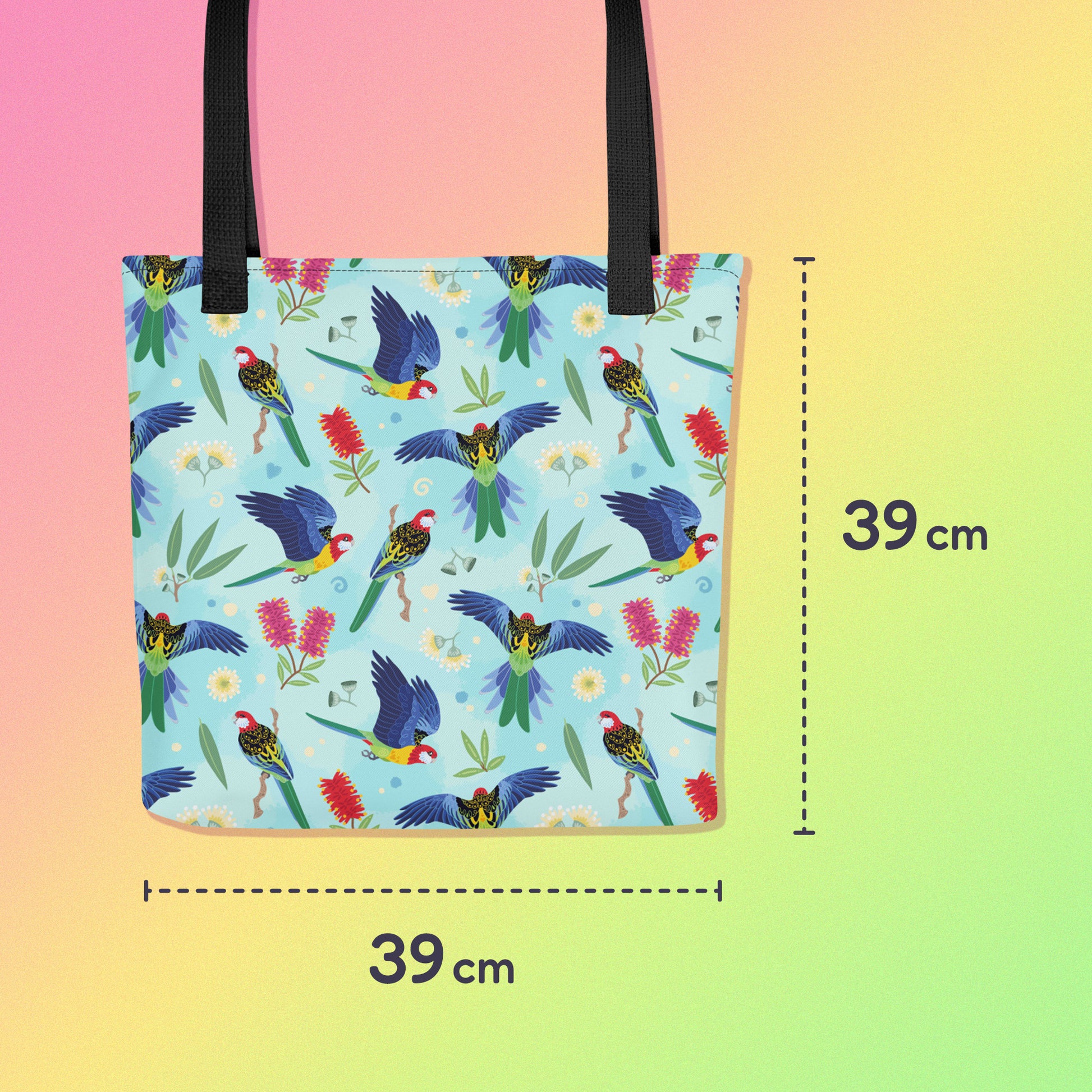 39 x 39 cm tote bag with black handles and an eastern rosella parrot pattern on a gradient pink, yellow and green background