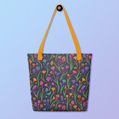 Tote bag with a yellow strap and a floral rainbow kangaroo paw pattern on a gradient blue and purple background.