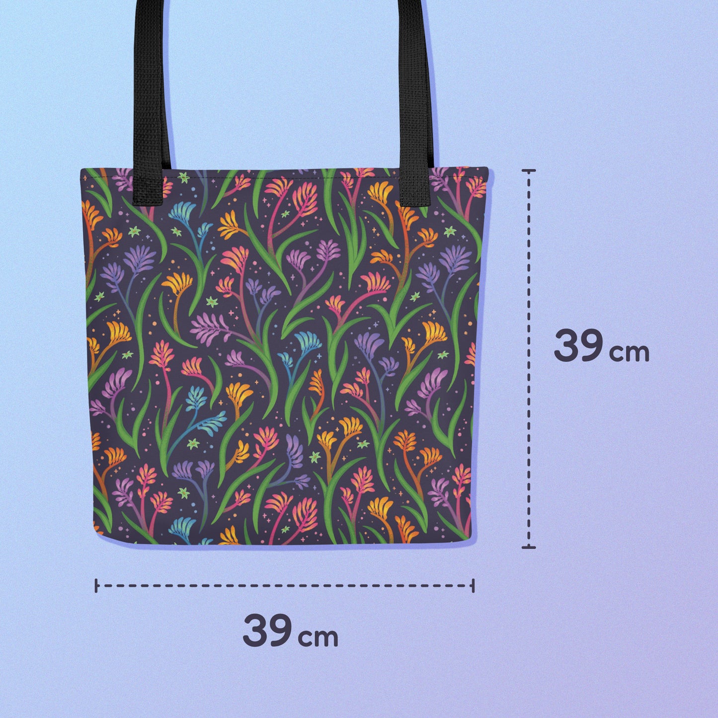 39x39cm tote bag with a black strap and a floral rainbow kangaroo paw pattern on a gradient blue and purple background.