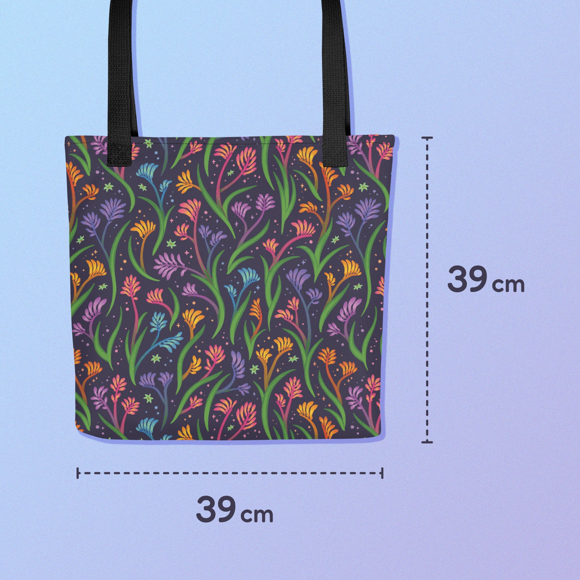 39x39cm tote bag with a black strap and a floral rainbow kangaroo paw pattern on a gradient blue and purple background.