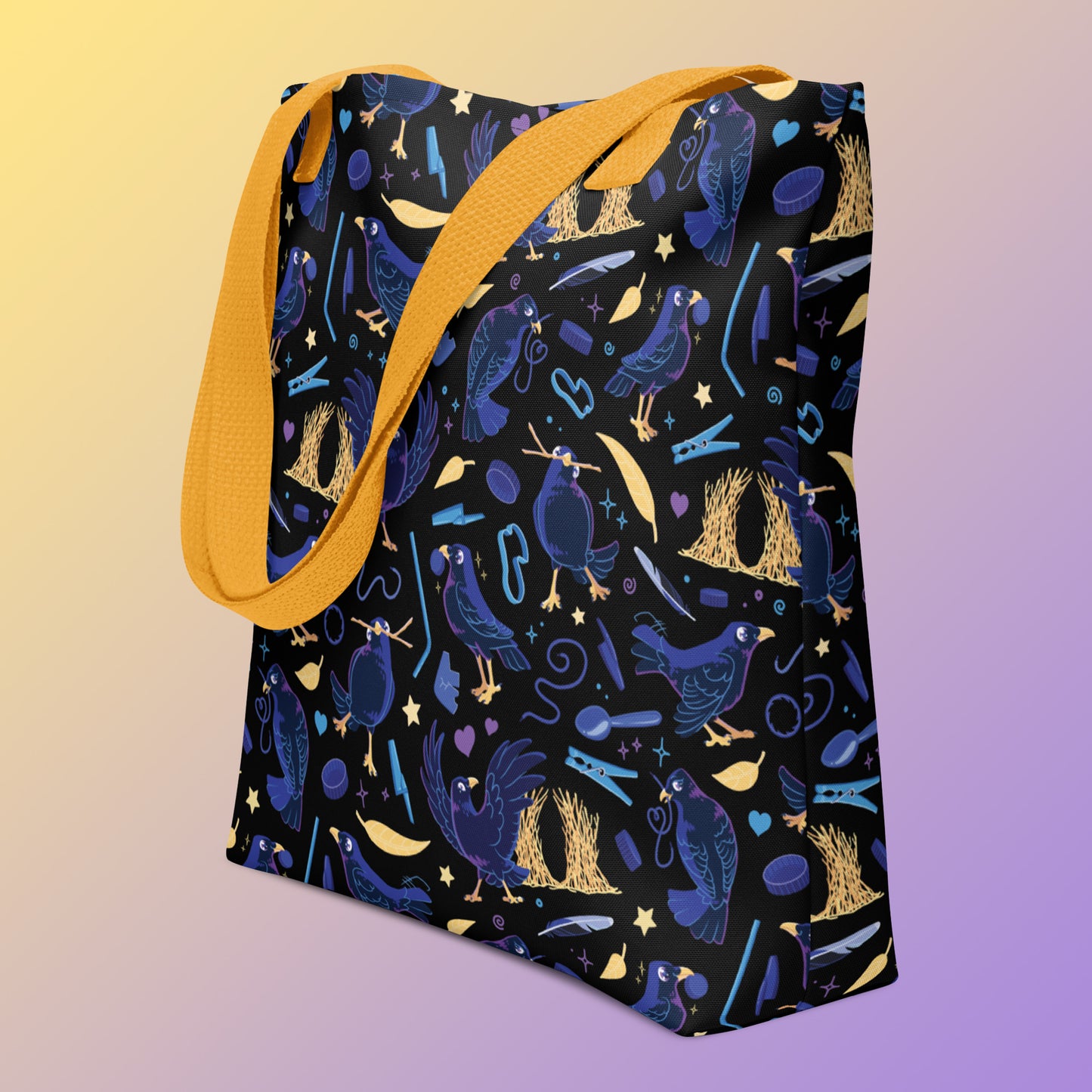 Tote bag with yellow handles and a black/blue/yellow satin bowerbird pattern pattern on an angle on a yellow and purple gradient background