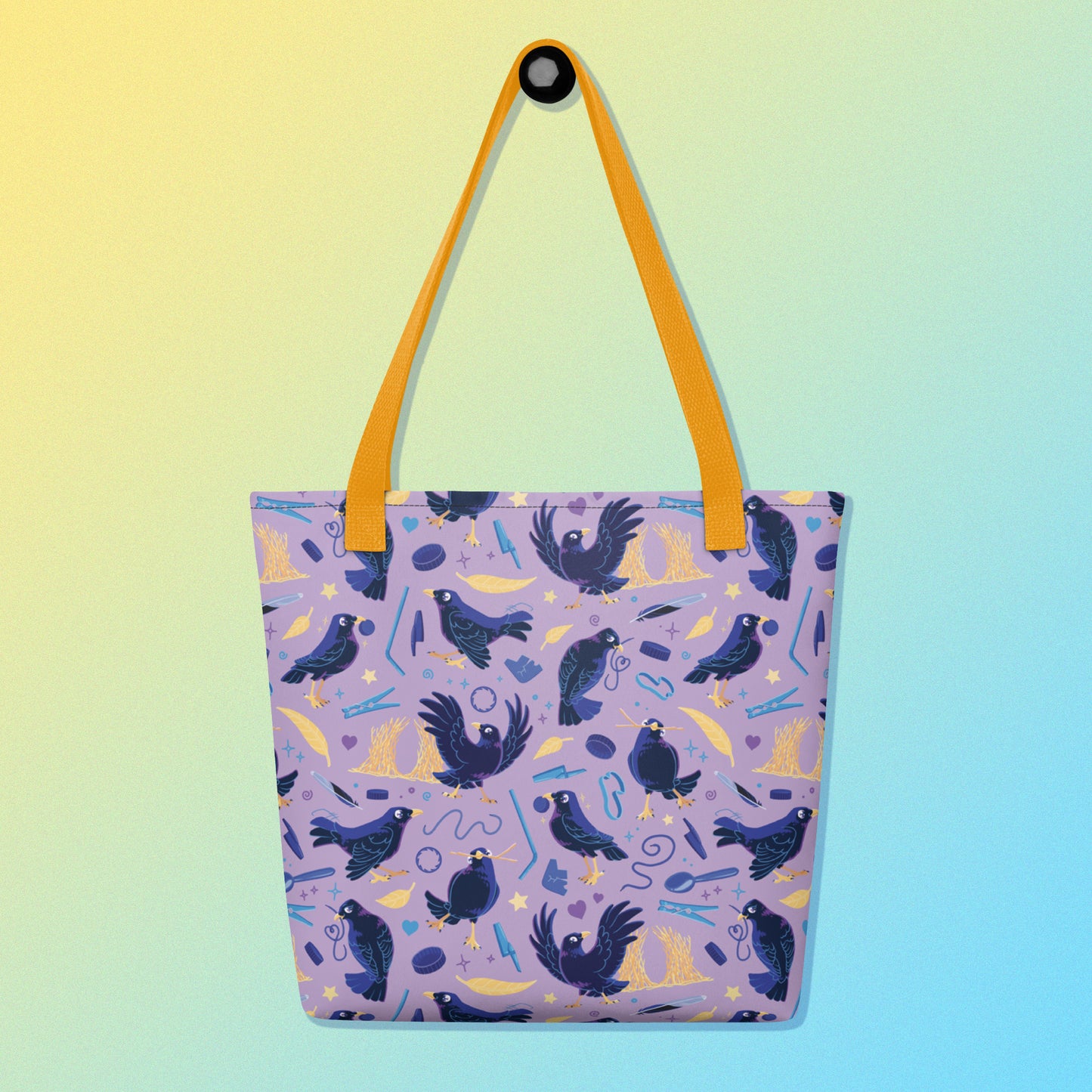 Tote bag with yellow handles and a purple/blue/yellow satin bowerbird pattern on a yellow and blue gradient background